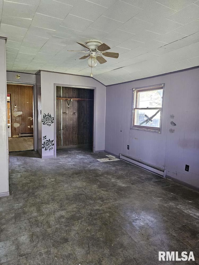 300 W Prairie St, Camp Point, IL 62320 - unfurnished living room with a baseboard radiator, ceiling fan, and wooden walls