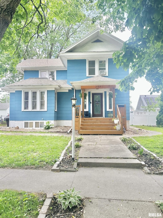 303 N Swarts St, Abingdon, IL 61410 - view of front facade with a porch, a front lawn, and roof with shingles
