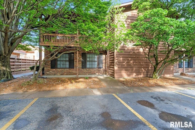 160 S Durkin Dr Unit 11, Springfield, IL 62704 - view of front of home featuring fence, uncovered parking, and brick siding