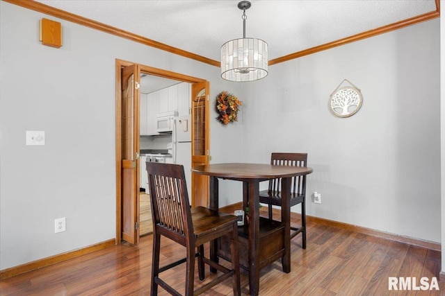 160 S Durkin Dr Unit 11, Springfield, IL 62704 - dining space with a chandelier, wood finished floors, crown molding, and baseboards