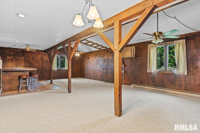 34831 Greenland Rd, Virden, IL 62690 - unfurnished living room with ceiling fan, wooden walls, healthy amount of natural light, and baseboard heating