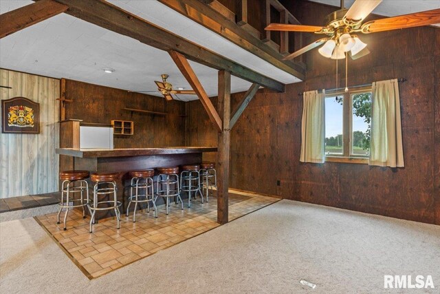 34831 Greenland Rd, Virden, IL 62690 - indoor dry bar with a ceiling fan, wood walls, carpet flooring, and beam ceiling