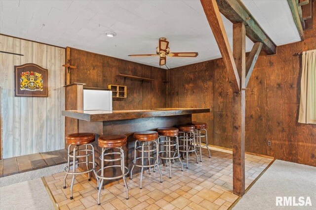 34831 Greenland Rd, Virden, IL 62690 - indoor dry bar with wooden walls, ceiling fan, fridge, and brick patterned floors
