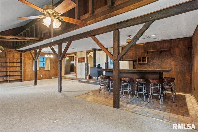 34831 Greenland Rd, Virden, IL 62690 - indoor dry bar with wooden walls, freestanding refrigerator, carpet floors, and a ceiling fan