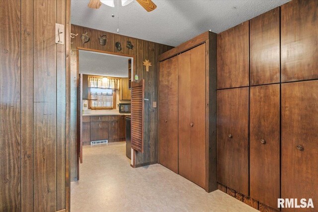 34831 Greenland Rd, Virden, IL 62690 - hall featuring wood walls and a textured ceiling