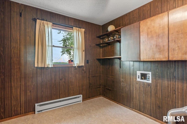 34831 Greenland Rd, Virden, IL 62690 - washroom featuring baseboard heating, wood walls, carpet, a textured ceiling, and cabinet space