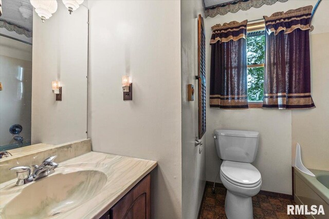 34831 Greenland Rd, Virden, IL 62690 - full bath featuring a bathtub, toilet, vanity, and baseboards