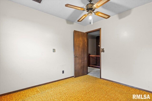 34831 Greenland Rd, Virden, IL 62690 - unfurnished room featuring light carpet, baseboards, a ceiling fan, and a textured ceiling