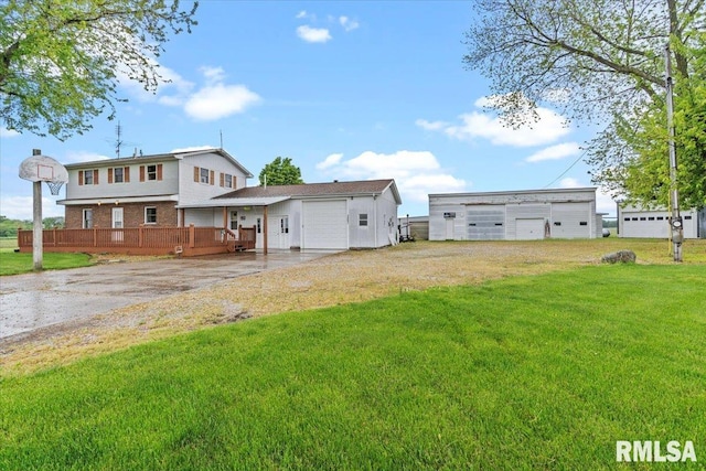 34831 Greenland Rd, Virden, IL 62690 - rear view of house featuring driveway, a yard, a wooden deck, and a garage