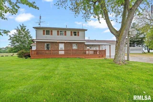 34831 Greenland Rd, Virden, IL 62690 - rear view of house with brick siding, a yard, a deck, and driveway