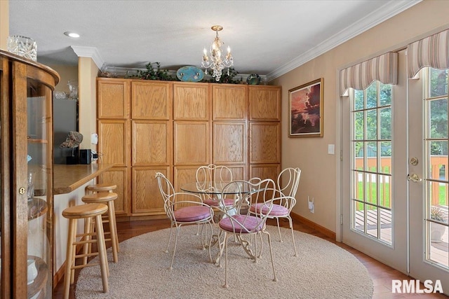 4 Nightingale Dr, Springfield, IL 62711 - dining space with ornamental molding, wood finished floors, a chandelier, french doors, and baseboards