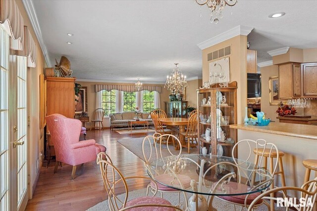 4 Nightingale Dr, Springfield, IL 62711 - dining room featuring ornamental molding, a chandelier, wood finished floors, french doors, and recessed lighting