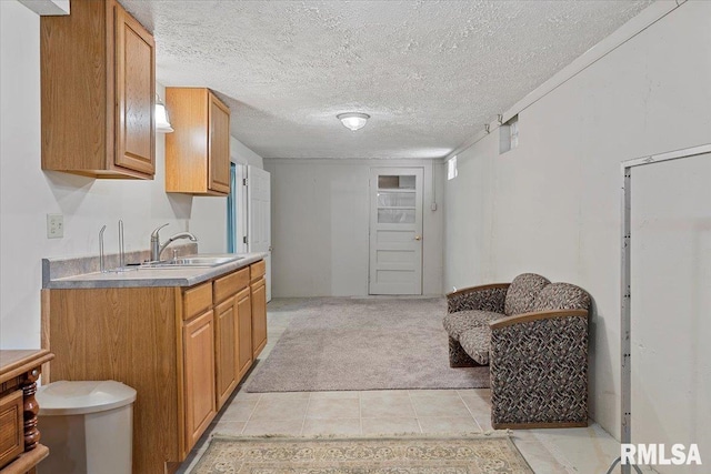 4 Nightingale Dr, Springfield, IL 62711 - kitchen with light colored carpet, a sink, light tile patterned flooring, brown cabinets, and a textured ceiling