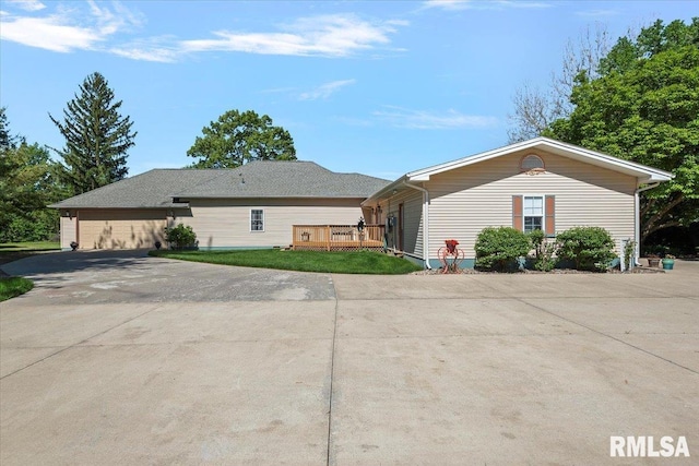 4 Nightingale Dr, Springfield, IL 62711 - view of front of home with a wooden deck, concrete driveway, and a front lawn