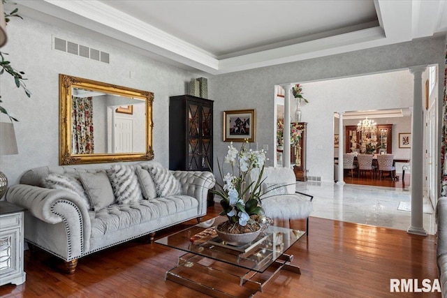 505 Clipper Rd, Springfield, IL 62704 - living room featuring a chandelier, ornate columns, a tray ceiling, ornamental molding, and wood finished floors