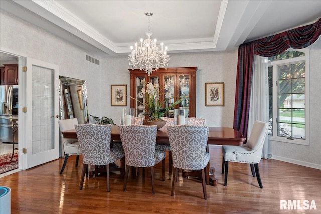 505 Clipper Rd, Springfield, IL 62704 - dining area featuring healthy amount of natural light, a chandelier, wood finished floors, a tray ceiling, and crown molding