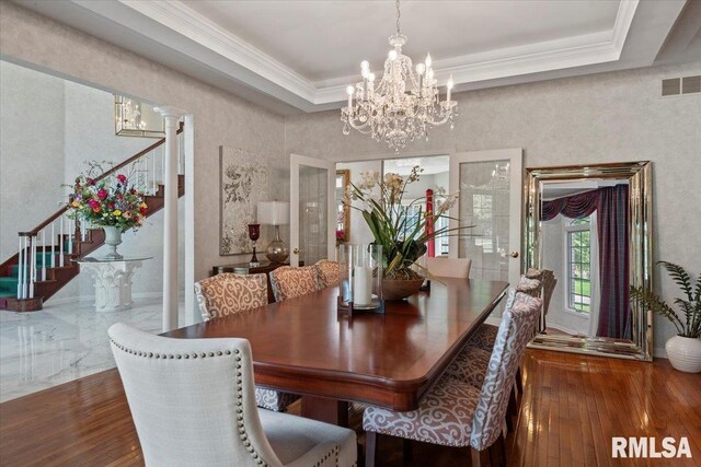 505 Clipper Rd, Springfield, IL 62704 - dining area with stairs, a chandelier, a tray ceiling, hardwood / wood-style flooring, and ornamental molding