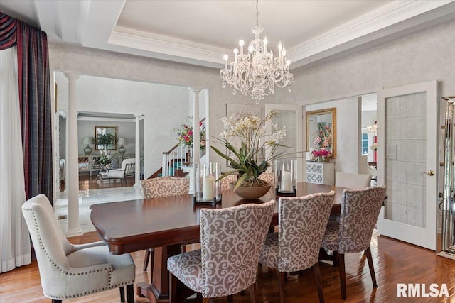 505 Clipper Rd, Springfield, IL 62704 - dining space with a chandelier, wood finished floors, ornate columns, ornamental molding, and a tray ceiling
