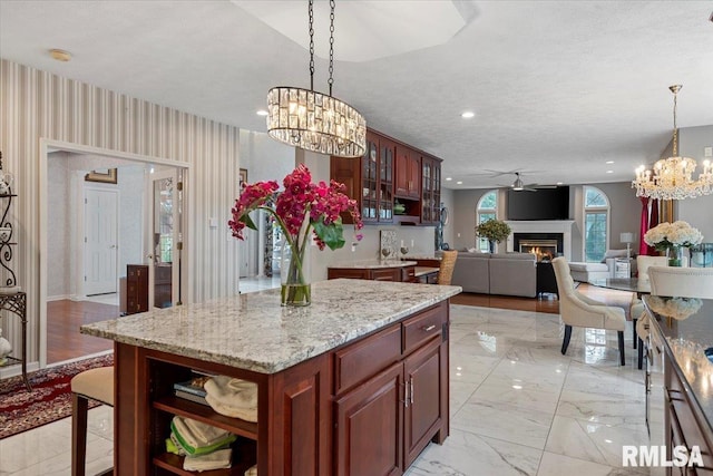 505 Clipper Rd, Springfield, IL 62704 - kitchen with a chandelier, a warm lit fireplace, decorative light fixtures, open shelves, and glass insert cabinets