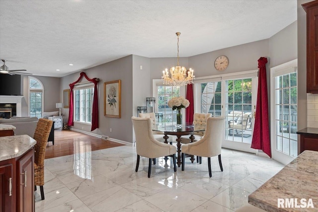 505 Clipper Rd, Springfield, IL 62704 - dining area with a chandelier, plenty of natural light, light marble finish flooring, a ceiling fan, and a textured ceiling