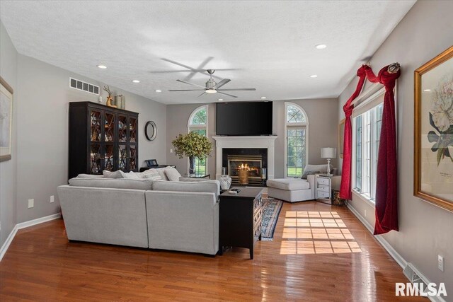 505 Clipper Rd, Springfield, IL 62704 - living area with wood finished floors, a ceiling fan, a glass covered fireplace, baseboards, and recessed lighting