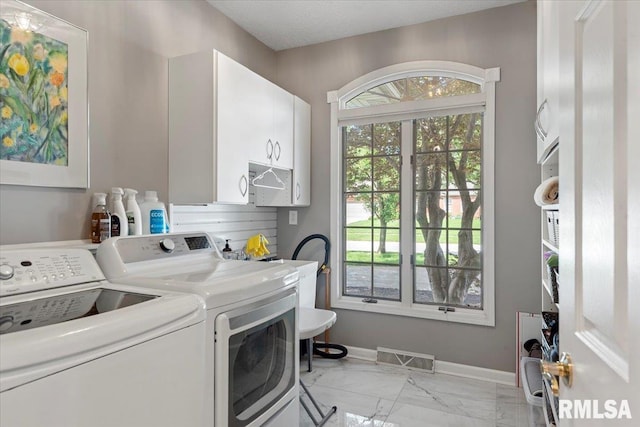 505 Clipper Rd, Springfield, IL 62704 - clothes washing area featuring cabinet space, washing machine and clothes dryer, light marble finish flooring, and baseboards
