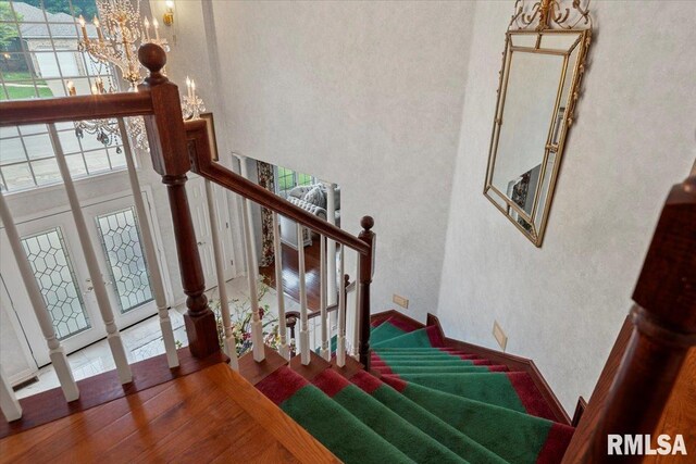 505 Clipper Rd, Springfield, IL 62704 - staircase featuring a high ceiling, a chandelier, and wood finished floors