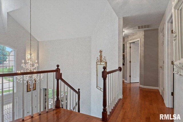 505 Clipper Rd, Springfield, IL 62704 - hallway with an upstairs landing, a chandelier, wood-type flooring, and high vaulted ceiling