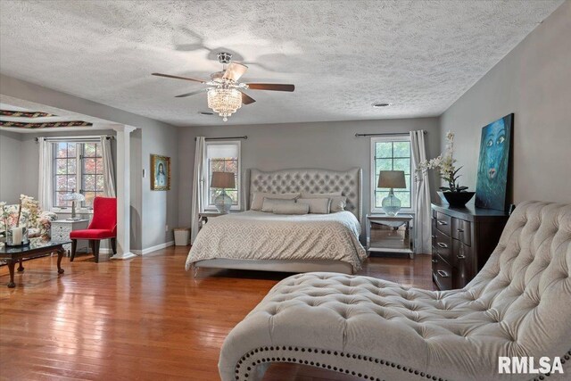 505 Clipper Rd, Springfield, IL 62704 - bedroom with wood finished floors, a textured ceiling, baseboards, and a ceiling fan