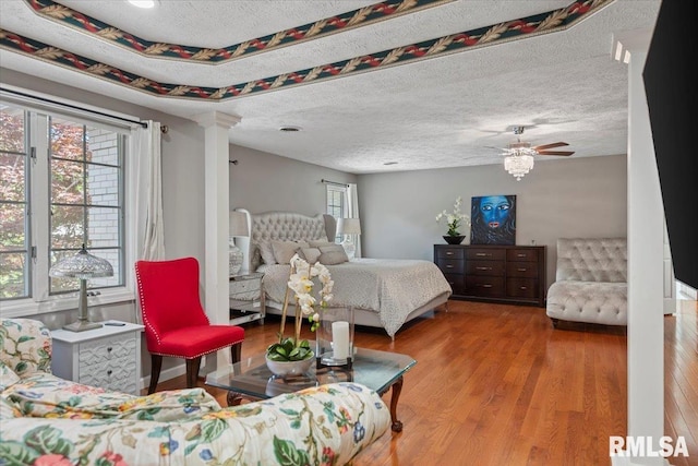 505 Clipper Rd, Springfield, IL 62704 - bedroom with wood finished floors, decorative columns, and a textured ceiling