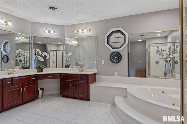 505 Clipper Rd, Springfield, IL 62704 - full bathroom featuring a shower stall, tile patterned flooring, a jetted tub, double vanity, and a textured ceiling
