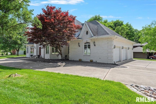505 Clipper Rd, Springfield, IL 62704 - view of front of house with a garage, a front lawn, driveway, brick siding, and roof with shingles