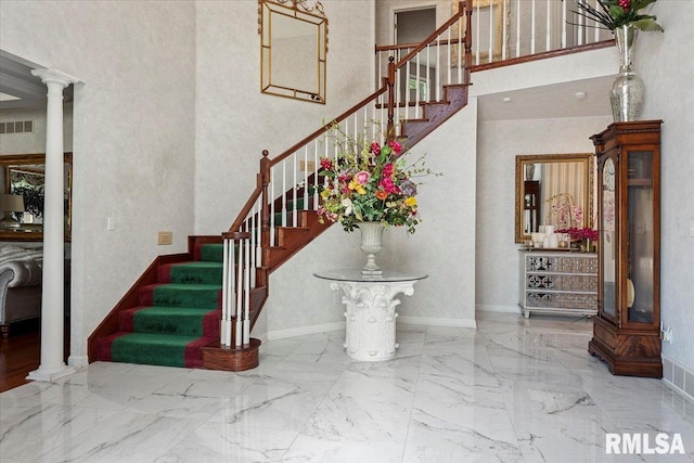 505 Clipper Rd, Springfield, IL 62704 - stairway featuring decorative columns, a towering ceiling, marble tiled floors, and baseboards
