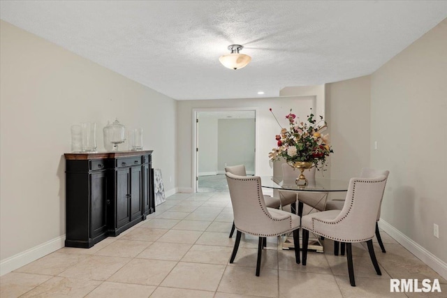 505 Clipper Rd, Springfield, IL 62704 - dining space featuring baseboards, a textured ceiling, and light tile patterned floors