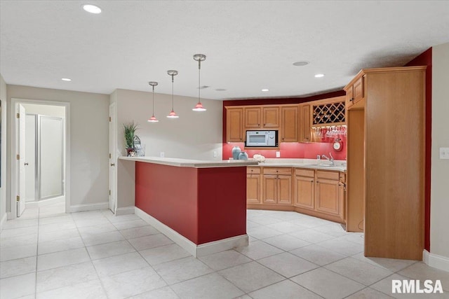505 Clipper Rd, Springfield, IL 62704 - kitchen featuring white microwave, a sink, a peninsula, light countertops, and recessed lighting