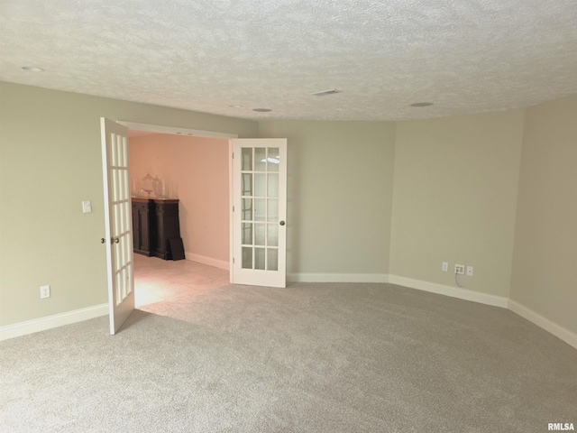 505 Clipper Rd, Springfield, IL 62704 - carpeted empty room with french doors, a textured ceiling, and baseboards