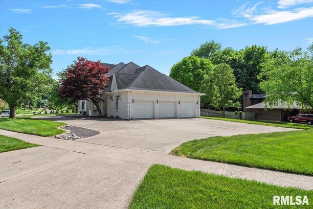 505 Clipper Rd, Springfield, IL 62704 - view of side of property with concrete driveway, an attached garage, and brick siding
