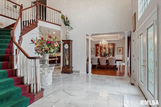 505 Clipper Rd, Springfield, IL 62704 - foyer entrance with a high ceiling, stairs, a chandelier, marble tiled flooring, and ornate columns