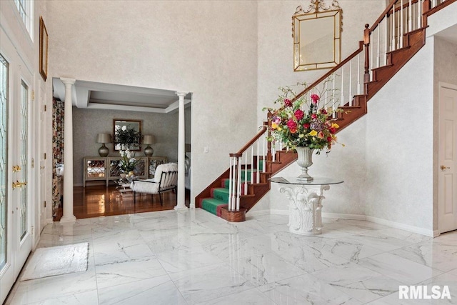 505 Clipper Rd, Springfield, IL 62704 - foyer featuring ornate columns, stairs, marble tiled flooring, a high ceiling, and baseboards