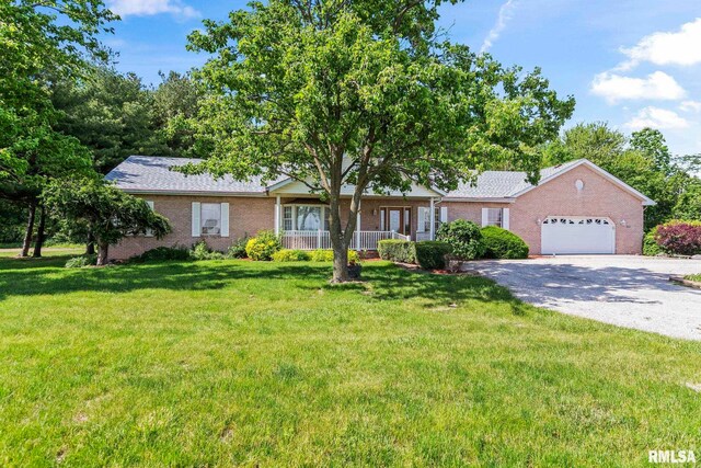 2087 N 700 E Rd, Edinburg, IL 62531 - ranch-style house featuring brick siding, gravel driveway, a garage, and a front yard