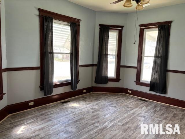 412 Pine St, Greenfield, IL 62044 - spare room with wood finished floors, ceiling fan, plenty of natural light, and baseboards