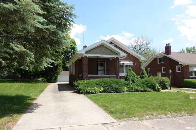 345 Division St, Galesburg, IL 61401 - bungalow featuring brick siding, a front lawn, and a porch