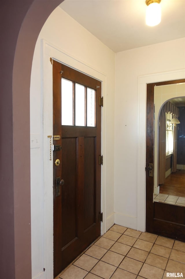 345 Division St, Galesburg, IL 61401 - foyer entrance with arched walkways, light tile patterned floors, and baseboards