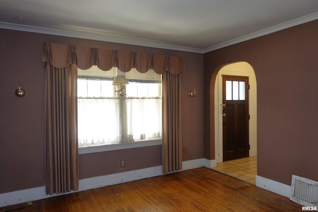 345 Division St, Galesburg, IL 61401 - foyer with arched walkways, plenty of natural light, ornamental molding, wood finished floors, and baseboards