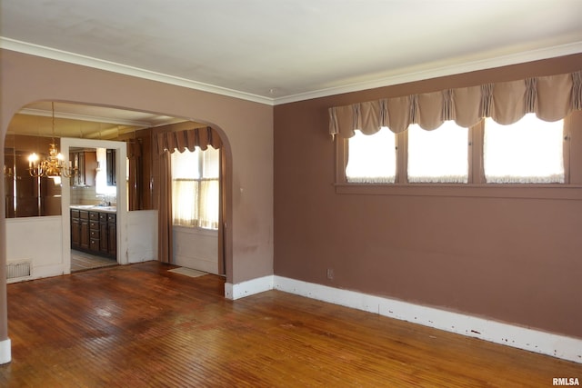 345 Division St, Galesburg, IL 61401 - unfurnished room with arched walkways, wood-type flooring, a chandelier, and ornamental molding