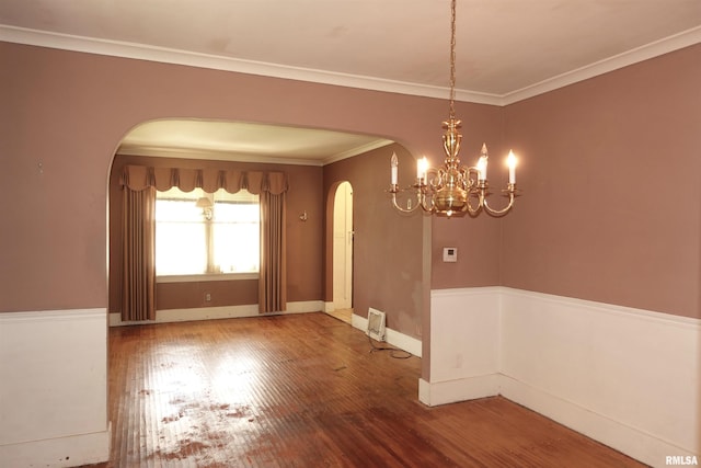 345 Division St, Galesburg, IL 61401 - unfurnished dining area with arched walkways, wood finished floors, a chandelier, baseboards, and ornamental molding