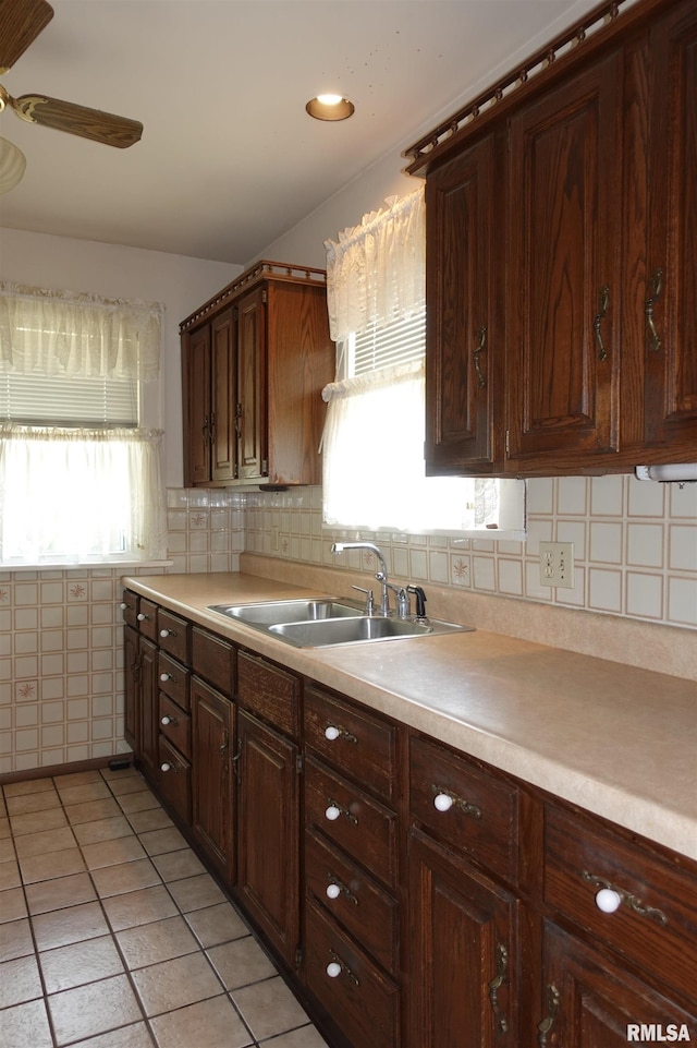 345 Division St, Galesburg, IL 61401 - kitchen with a sink, ceiling fan, light countertops, light tile patterned floors, and backsplash