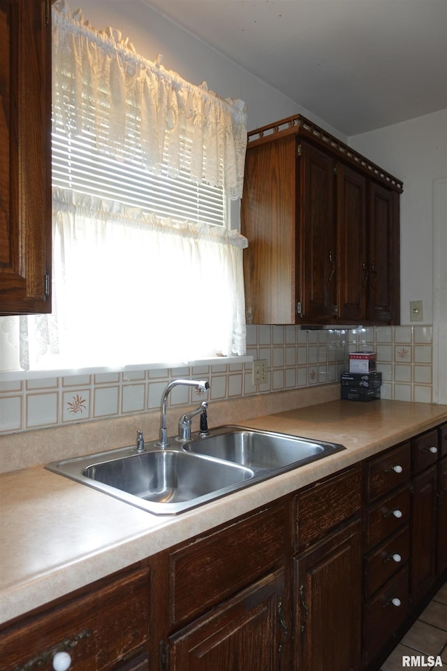 345 Division St, Galesburg, IL 61401 - kitchen featuring a sink, tasteful backsplash, light countertops, and dark brown cabinets