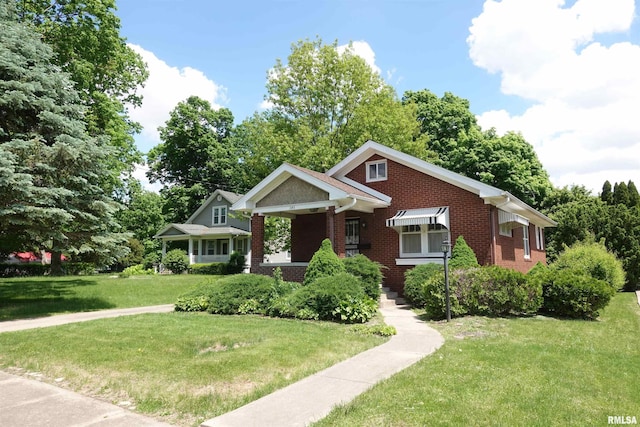 345 Division St, Galesburg, IL 61401 - bungalow-style home featuring brick siding and a front yard