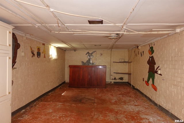 345 Division St, Galesburg, IL 61401 - corridor with brick wall, unfinished concrete flooring, and baseboards